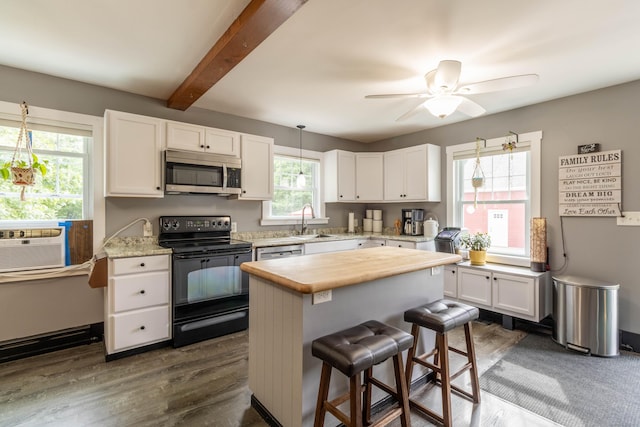 534 Norwich Ave, Colchester, CT 06415 - kitchen with appliances with stainless steel finishes, white cabinetry, a kitchen island, cooling unit, and a breakfast bar area