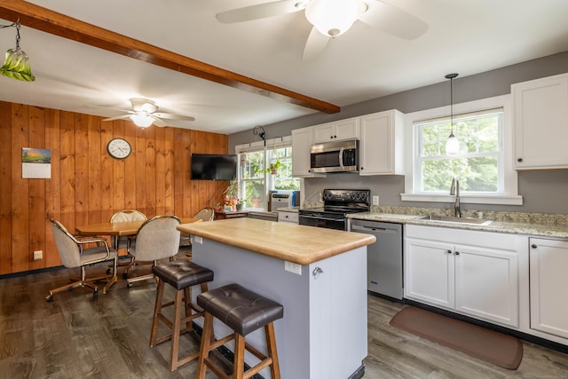 534 Norwich Ave, Colchester, CT 06415 - kitchen with stainless steel appliances, a ceiling fan, light countertops, beamed ceiling, and a center island