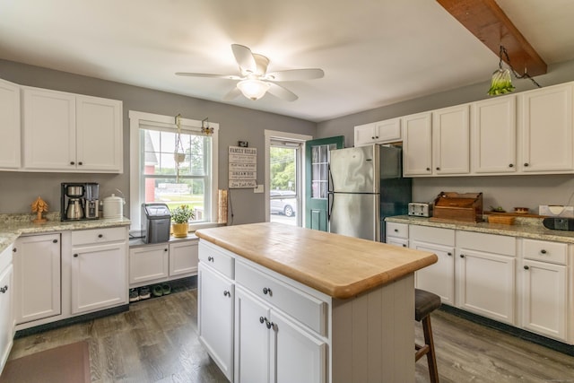 534 Norwich Ave, Colchester, CT 06415 - kitchen featuring freestanding refrigerator, ceiling fan, dark wood-style flooring, and white cabinetry