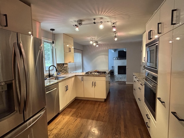 11 Obed Hts, Old Saybrook, CT 06475 - kitchen with stainless steel appliances, a peninsula, a fireplace, and dark wood-style floors