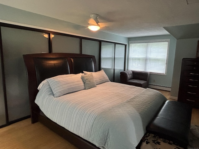 11 Obed Hts, Old Saybrook, CT 06475 - bedroom with a baseboard heating unit, light wood finished floors, and ceiling fan