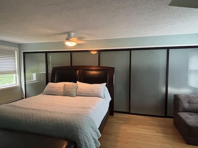 11 Obed Hts, Old Saybrook, CT 06475 - bedroom featuring wood finished floors, a textured ceiling, and a ceiling fan