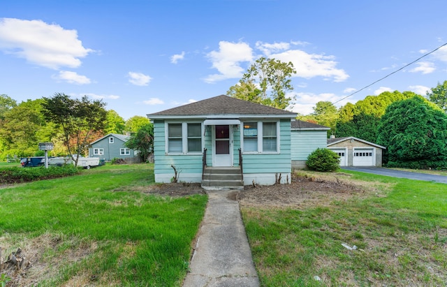 205 Old Norwich Rd, Waterford, CT 06375 - bungalow-style house featuring entry steps, a garage, an outbuilding, a front yard, and a shingled roof