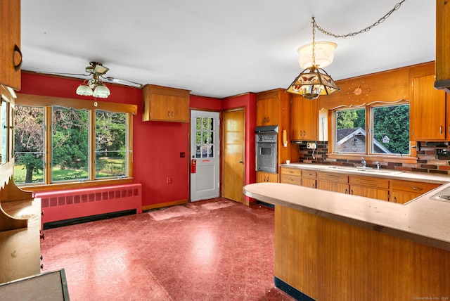 205 Old Norwich Rd, Waterford, CT 06375 - kitchen with radiator, a ceiling fan, dark flooring, and brown cabinets