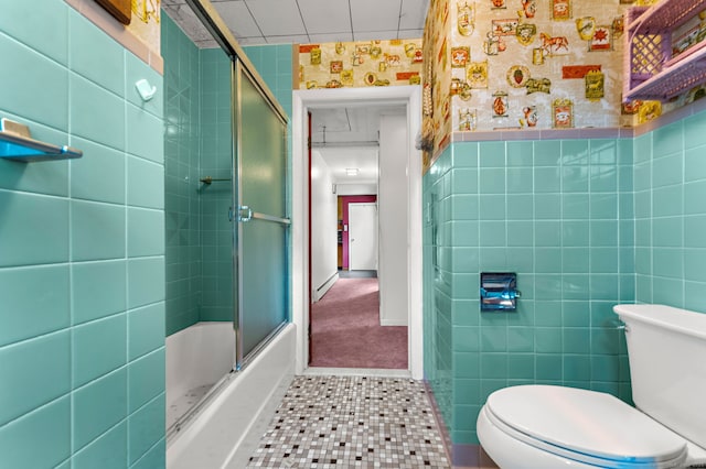 205 Old Norwich Rd, Waterford, CT 06375 - bathroom with tile patterned floors, wallpapered walls, bath / shower combo with glass door, and tile walls