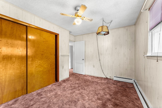 205 Old Norwich Rd, Waterford, CT 06375 - unfurnished bedroom featuring carpet, wooden walls, a closet, baseboard heating, and a ceiling fan