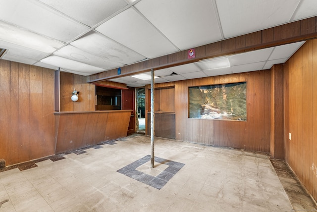 205 Old Norwich Rd, Waterford, CT 06375 - finished below grade area with tile patterned floors, a paneled ceiling, wooden walls, and a dry bar