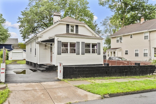 173 Euclid St W, Hartford, CT 06112 - view of front of home featuring entry steps, an outbuilding, and a chimney