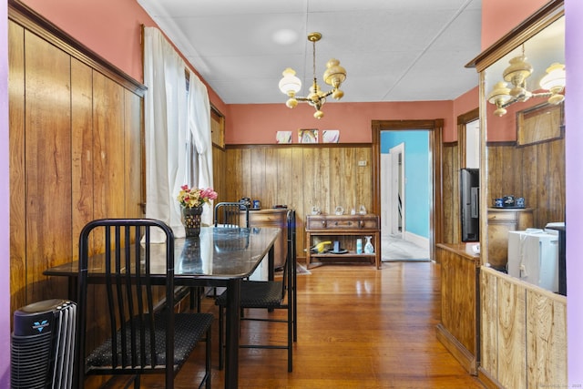 173 Euclid St W, Hartford, CT 06112 - dining area with a chandelier, wood finished floors, wooden walls, and healthy amount of natural light