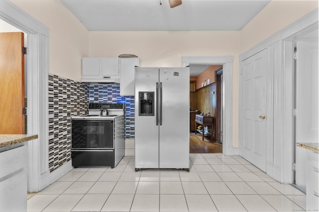 173 Euclid St W, Hartford, CT 06112 - kitchen with stainless steel refrigerator with ice dispenser, electric stove, white cabinets, light tile patterned flooring, and under cabinet range hood