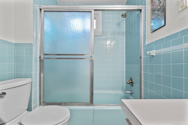 173 Euclid St W, Hartford, CT 06112 - bathroom featuring tile walls, shower / bath combination with glass door, and vanity