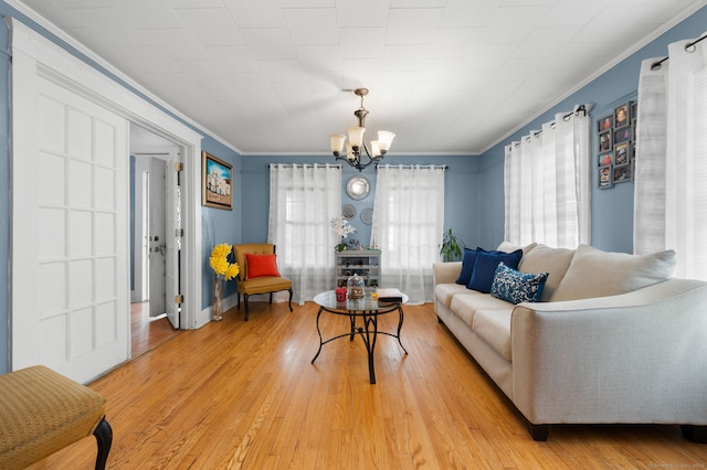 28 W High St, New London, CT 06320 - living room featuring a chandelier, crown molding, and light wood-type flooring