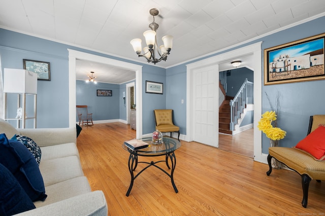 28 W High St, New London, CT 06320 - living area featuring a chandelier, crown molding, light wood-style flooring, and stairs