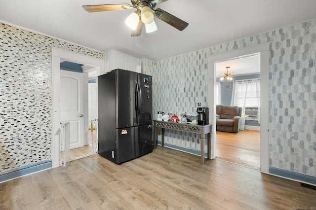 28 W High St, New London, CT 06320 - kitchen with freestanding refrigerator, wallpapered walls, white cabinetry, light wood-style floors, and ceiling fan