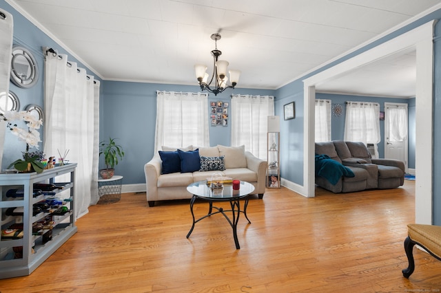 28 W High St, New London, CT 06320 - living area featuring healthy amount of natural light, ornamental molding, a chandelier, and light wood-type flooring
