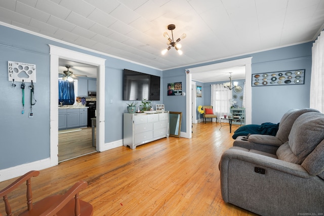 28 W High St, New London, CT 06320 - living area featuring a chandelier, crown molding, light wood-style floors, and a ceiling fan