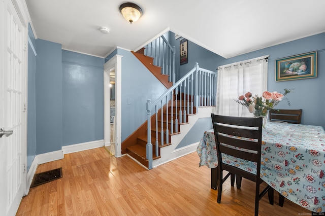 28 W High St, New London, CT 06320 - dining room with wood finished floors, stairway, and crown molding