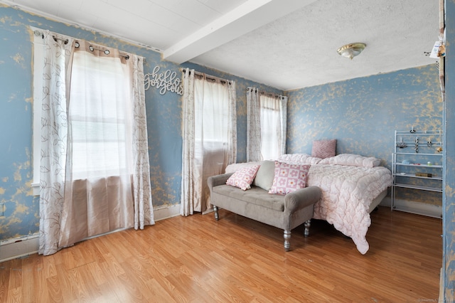28 W High St, New London, CT 06320 - bedroom featuring wallpapered walls, wood finished floors, and beamed ceiling