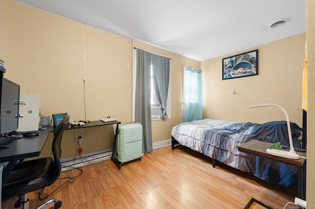 28 W High St, New London, CT 06320 - bedroom featuring wood finished floors, a desk, and a baseboard heating unit