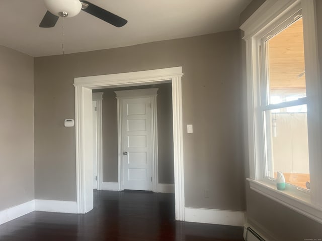 155 Summerfield Ave, Bridgeport, CT 06610 - empty room featuring a baseboard heating unit, a ceiling fan, and dark wood-type flooring