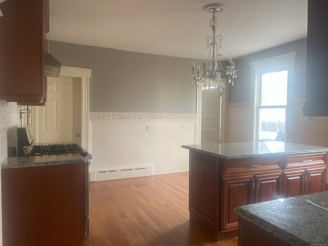 155 Summerfield Ave, Bridgeport, CT 06610 - kitchen featuring a wainscoted wall, a chandelier, wood finished floors, decorative light fixtures, and baseboard heating