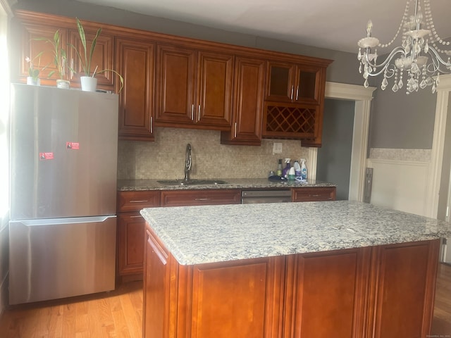 155 Summerfield Ave, Bridgeport, CT 06610 - kitchen with stainless steel appliances, light stone countertops, light wood-style floors, and a kitchen island