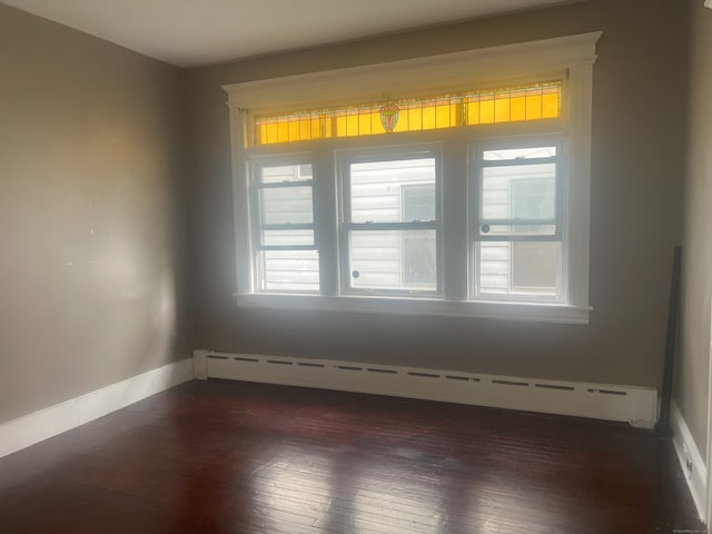 155 Summerfield Ave, Bridgeport, CT 06610 - spare room featuring baseboard heating and dark wood-type flooring