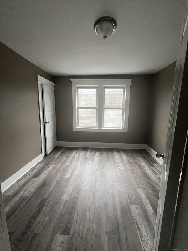 155 Summerfield Ave, Bridgeport, CT 06610 - spare room with dark wood-style floors and baseboards