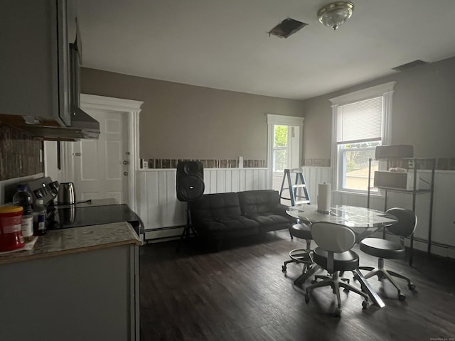 155 Summerfield Ave, Bridgeport, CT 06610 - dining space featuring dark wood finished floors, a baseboard radiator, and wainscoting