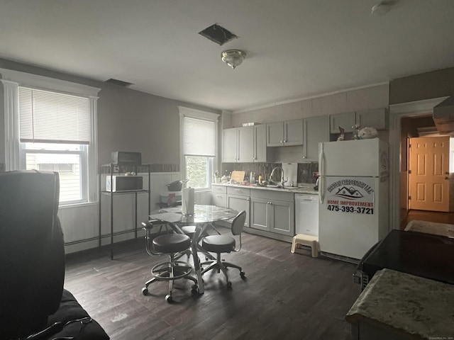 155 Summerfield Ave, Bridgeport, CT 06610 - dining room with a baseboard heating unit and wood finished floors