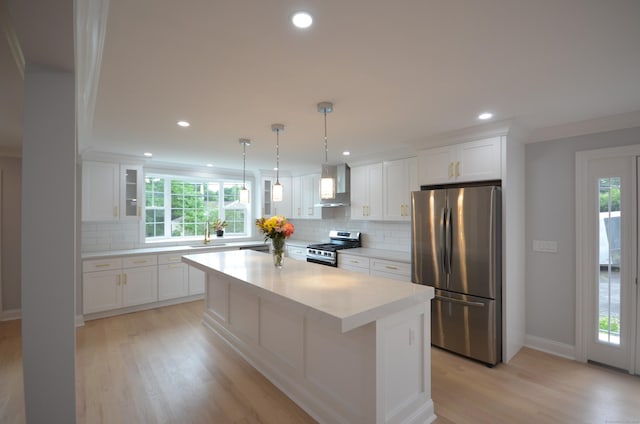 401 Unity Rd, Trumbull, CT 06611 - kitchen with stainless steel appliances, wall chimney range hood, plenty of natural light, light wood-style floors, and recessed lighting