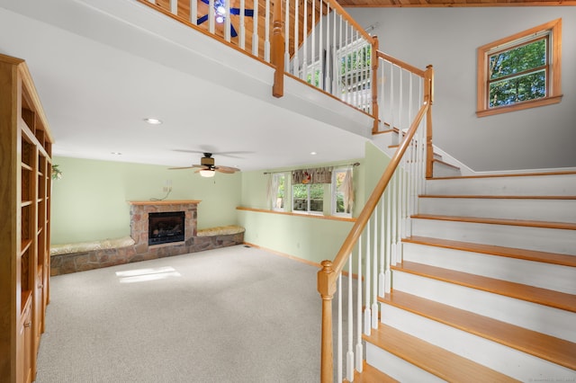 16 Lake St, Burlington, CT 06013 - unfurnished living room featuring a stone fireplace, stairs, carpet floors, a ceiling fan, and recessed lighting