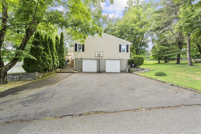 124 Pulaski Hwy, Ansonia, CT 06401 - view of property exterior featuring driveway, stairs, an attached garage, and a yard