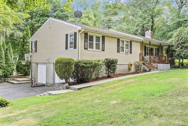 124 Pulaski Hwy, Ansonia, CT 06401 - single story home with a garage, a chimney, a front lawn, asphalt driveway, and a porch