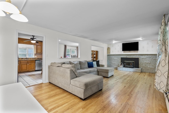 124 Pulaski Hwy, Ansonia, CT 06401 - living area with light wood finished floors, a brick fireplace, and a ceiling fan