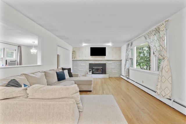 124 Pulaski Hwy, Ansonia, CT 06401 - living room with baseboard heating, healthy amount of natural light, wood finished floors, and a chandelier