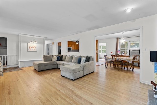 124 Pulaski Hwy, Ansonia, CT 06401 - living area featuring light wood-style flooring, cooling unit, and a chandelier