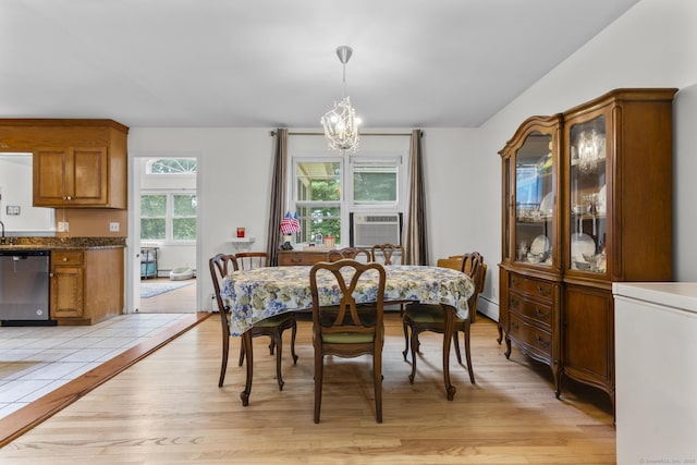 124 Pulaski Hwy, Ansonia, CT 06401 - dining area featuring light wood-style floors, a chandelier, cooling unit, and a baseboard radiator