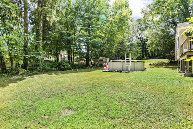 124 Pulaski Hwy, Ansonia, CT 06401 - view of green lawn with an outdoor pool, view of scattered trees, and a playground