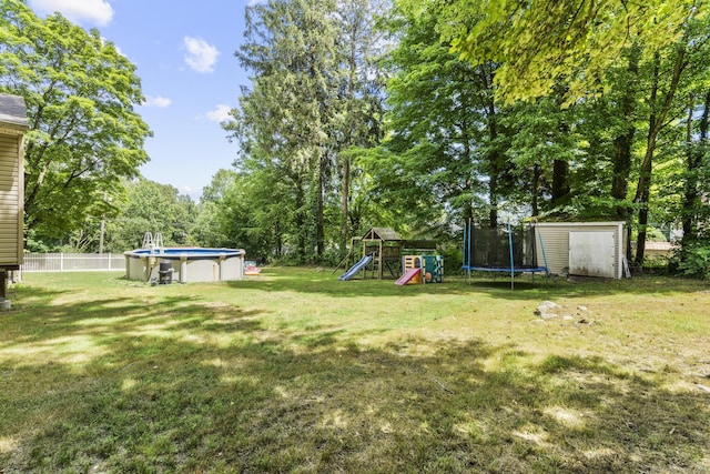 124 Pulaski Hwy, Ansonia, CT 06401 - view of yard with a trampoline, a storage shed, a playground, and an outdoor pool