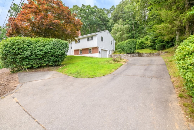 37 Cedar Ln, Beacon Falls, CT 06403 - view of front of home with brick siding, asphalt driveway, a garage, and a front yard