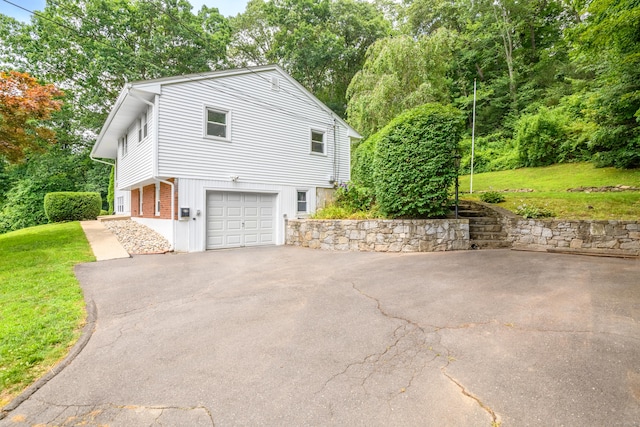 37 Cedar Ln, Beacon Falls, CT 06403 - view of side of property with a garage, asphalt driveway, and a lawn