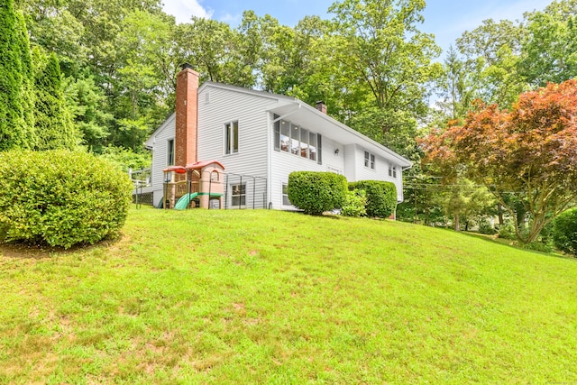 37 Cedar Ln, Beacon Falls, CT 06403 - view of home's exterior with a chimney, a yard, and view of wooded area