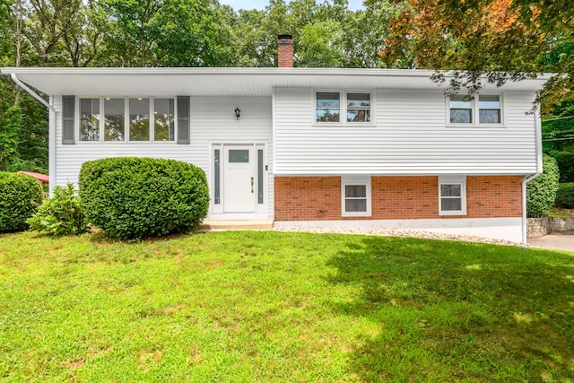 37 Cedar Ln, Beacon Falls, CT 06403 - bi-level home with a front lawn, brick siding, and a chimney