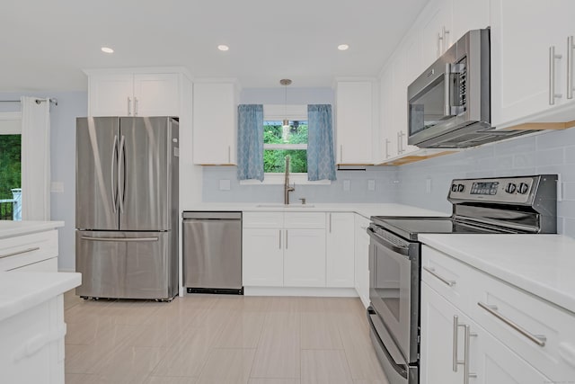37 Cedar Ln, Beacon Falls, CT 06403 - kitchen with appliances with stainless steel finishes, white cabinets, light countertops, tasteful backsplash, and recessed lighting