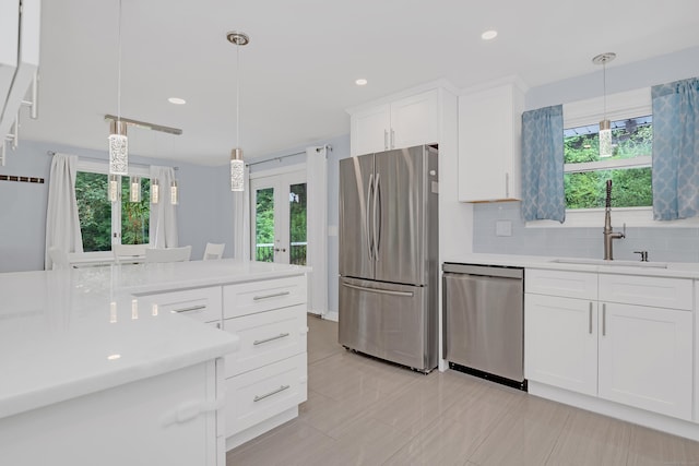 37 Cedar Ln, Beacon Falls, CT 06403 - kitchen with appliances with stainless steel finishes, french doors, light countertops, white cabinetry, and decorative light fixtures