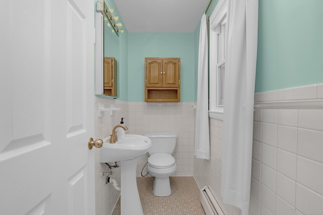 37 Cedar Ln, Beacon Falls, CT 06403 - bathroom with tile walls, tile patterned floors, a wainscoted wall, a baseboard heating unit, and curtained shower