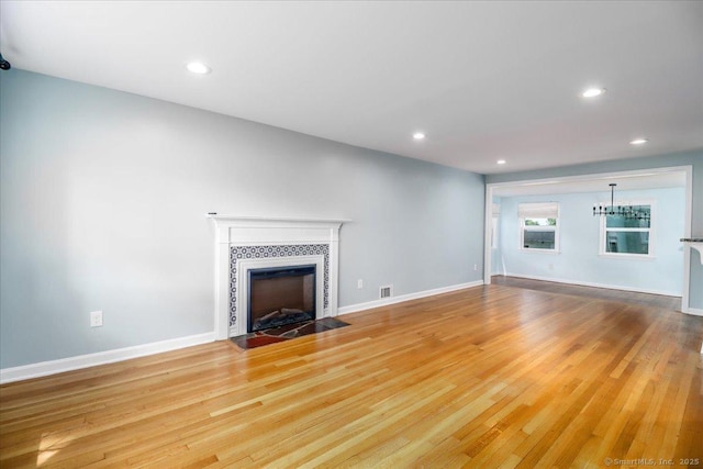 234 Forest Dr, Wethersfield, CT 06109 - unfurnished living room with light wood finished floors, recessed lighting, and a tile fireplace