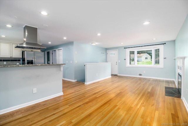 234 Forest Dr, Wethersfield, CT 06109 - unfurnished living room featuring light wood finished floors, recessed lighting, and a fireplace with flush hearth