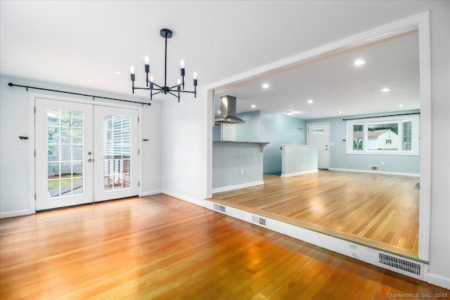 234 Forest Dr, Wethersfield, CT 06109 - unfurnished dining area with wood finished floors, french doors, a chandelier, and recessed lighting